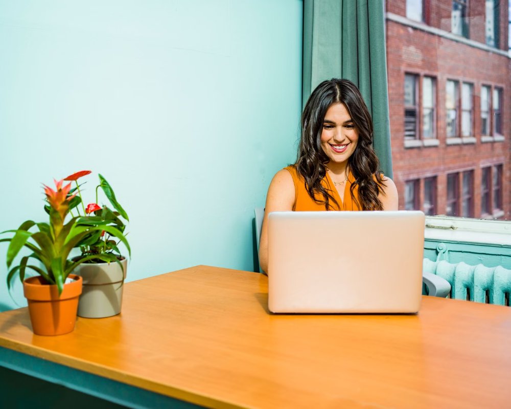 A woman building her website on a laptop